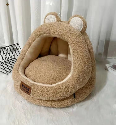 The Ultra Soft Cat Nest by KittyNook Cat Co. is a tan, bear-shaped bed with plush interior—perfect for anxiety relief.